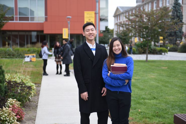 two students standing in front of the nexus building on the garden city campus