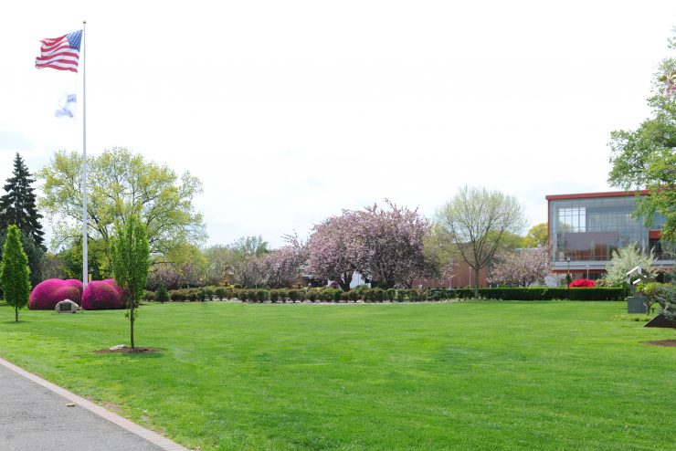 Flagpole Lawn at ӰƬ is an open green space full of flowers and trees.