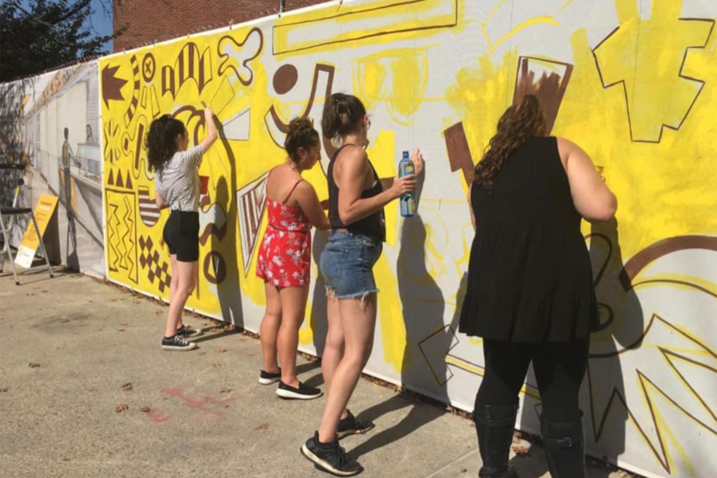 ӰƬ students painting a temporary mural on campus during the 2019 Fall Arts Festival.