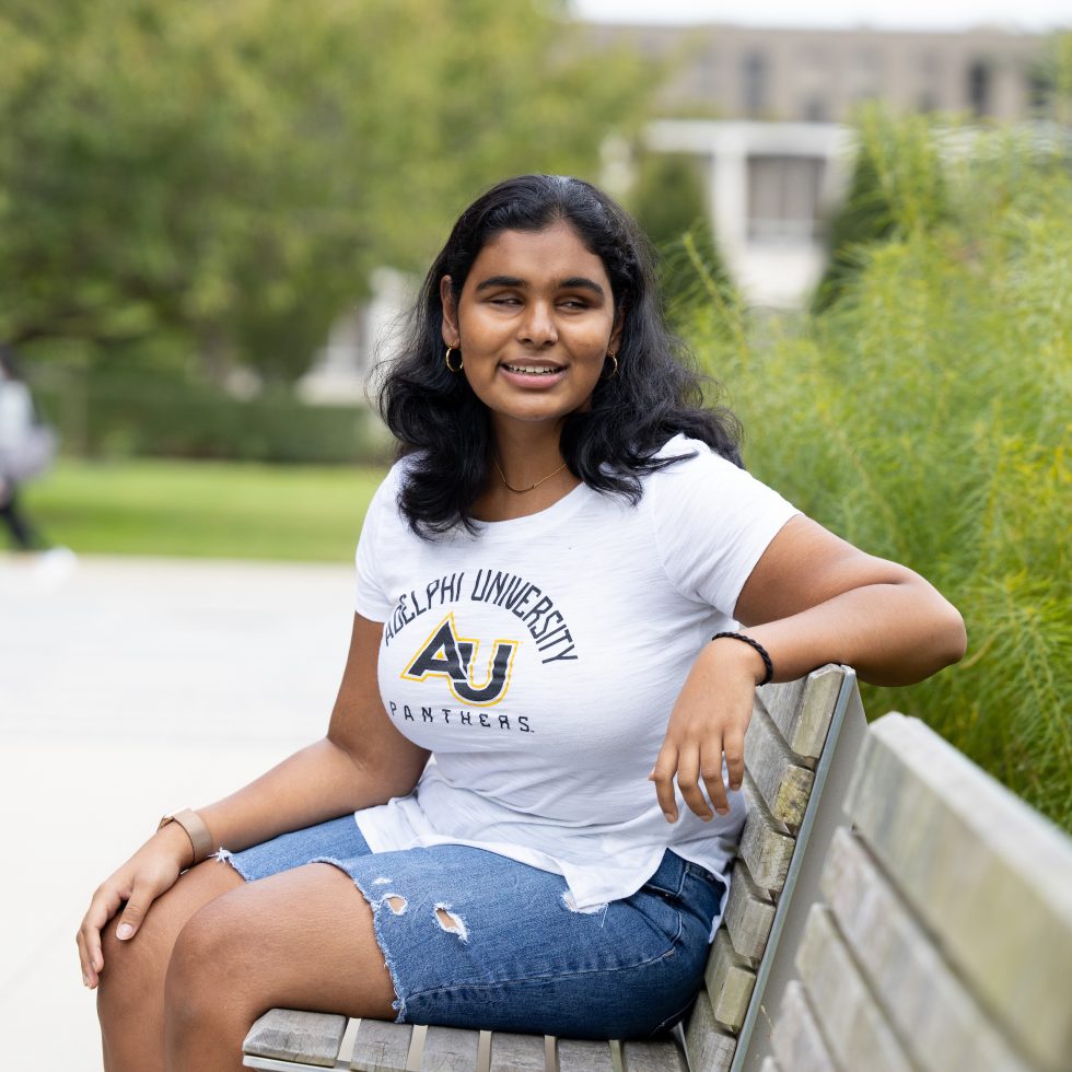 Jessica Karim sitting on a bench at ӰƬ University's Garden City campus.