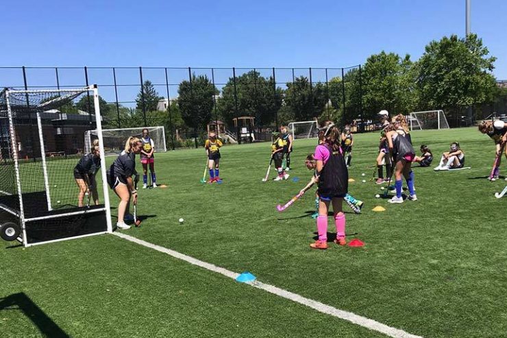 While at ӰƬ University, campers are placed into small groups to work on their field hockey fundamentals.