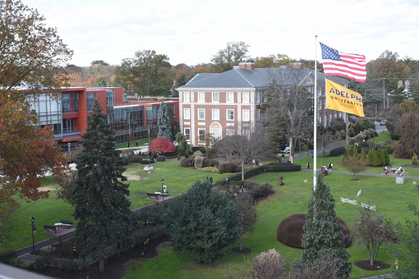 Aerial view of ӰƬ University, Garden City campus - Showing Nexus Building, Levermore Hall and the Flagpole lawn with both American and ӰƬ flags waving.