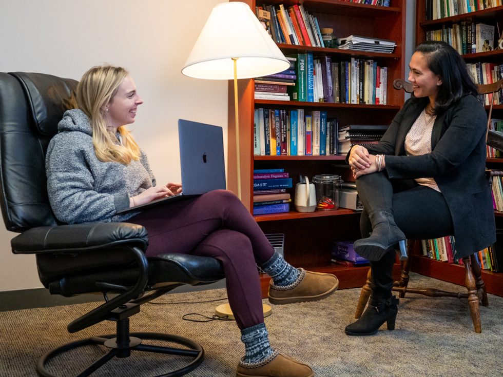 Monica Pal, PhD '13, speaking with a student at ӰƬ's Center for Psychological Services and director of Practicum Training